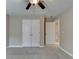 Bedroom featuring closet, ceiling fan, and access to the hall at 4340 Bluejay Pl, Cumming, GA 30041