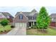 Beautiful brick home with well maintained landscaping, dark shutters, and a two car garage at 4340 Bluejay Pl, Cumming, GA 30041