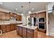 A kitchen featuring stainless steel appliances, granite countertops, a kitchen island, and wooden cabinets at 4340 Bluejay Pl, Cumming, GA 30041