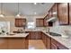 Modern kitchen with stainless steel appliances, granite counters, and wood cabinets at 4340 Bluejay Pl, Cumming, GA 30041