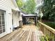 Spacious wooden back deck with an outdoor dining area and gazebo at 525 S Lost Lake Cv, Villa Rica, GA 30180