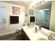 Well-lit bathroom features a double sink vanity with white countertop and framed mirror at 525 S Lost Lake Cv, Villa Rica, GA 30180