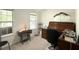 Bright bedroom with natural light, featuring traditional desk and ample workspace at 525 S Lost Lake Cv, Villa Rica, GA 30180