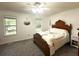 A relaxing bedroom with a ceiling fan, carpeted floors, and bright windows at 525 S Lost Lake Cv, Villa Rica, GA 30180