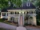 Inviting home exterior with a long porch, string lights, and manicured landscaping at 525 S Lost Lake Cv, Villa Rica, GA 30180