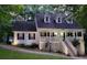 Charming two-story home with dormer windows, a large porch, and landscaped yard at 525 S Lost Lake Cv, Villa Rica, GA 30180