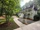 Charming two-story home featuring a welcoming front porch, a well-manicured lawn and a mature tree at 525 S Lost Lake Cv, Villa Rica, GA 30180