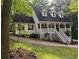 Charming two-story home featuring a welcoming front porch with dormer windows and landscaped surroundings at 525 S Lost Lake Cv, Villa Rica, GA 30180
