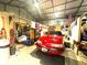 Spacious garage interior with red car, overhead lighting, and ample storage space at 525 S Lost Lake Cv, Villa Rica, GA 30180