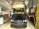 Garage with car lift, black car below, and organized shelves in the background at 525 S Lost Lake Cv, Villa Rica, GA 30180