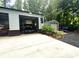 View of two-car garage with car on lift, and additional storage shed at 525 S Lost Lake Cv, Villa Rica, GA 30180