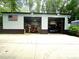 View of the two-car garage with red car, lift, and black car inside at 525 S Lost Lake Cv, Villa Rica, GA 30180