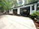 Wide shot of the two-car garage, car lift, and two-tone exterior at 525 S Lost Lake Cv, Villa Rica, GA 30180