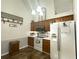 Bright kitchen featuring wood cabinets, modern appliances, and wood floors at 525 S Lost Lake Cv, Villa Rica, GA 30180