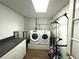 Bright laundry room with washer, dryer, countertop, and ample storage space at 525 S Lost Lake Cv, Villa Rica, GA 30180