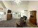 Bright living room features high ceilings, neutral carpet, lots of natural light, and a view into the dining area at 525 S Lost Lake Cv, Villa Rica, GA 30180
