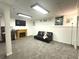 Finished basement area with decorative fireplace, futon and full mirrored wall at 525 S Lost Lake Cv, Villa Rica, GA 30180