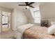 Attic bedroom features angled ceilings, neutral carpet, and an connecting view to the bathroom at 4420 Little Falls Dr, Cumming, GA 30041