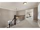 Upstairs hallway with carpet floors leading to a bedroom at 4420 Little Falls Dr, Cumming, GA 30041