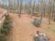 An expansive and wooded backyard with various structures and a trampoline at 270 Cochran Ridge Rd, Dallas, GA 30157