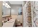Cozy bathroom with a large sink, large mirror, and unique shower curtain at 270 Cochran Ridge Rd, Dallas, GA 30157