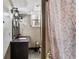 Basement bathroom with tiled floor, decorative sconces, dark vanity, and patterned shower curtain at 270 Cochran Ridge Rd, Dallas, GA 30157