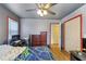 A modern bedroom with blue walls, wood floors, and closet at 270 Cochran Ridge Rd, Dallas, GA 30157