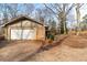 Attached one-car garage of brick home, featuring a white garage door and driveway at 270 Cochran Ridge Rd, Dallas, GA 30157