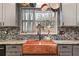 Close up of kitchen sink featuring stainless steel appliances, custom cabinets, and copper farmhouse sink at 270 Cochran Ridge Rd, Dallas, GA 30157
