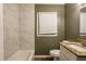 This bathroom features neutral walls, updated white tile on the walls and a granite sink at 285 Argus Nw Cir, Atlanta, GA 30331