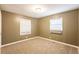 Bedroom featuring neutral walls, carpet flooring, and two bright windows, creating a comfortable atmosphere at 285 Argus Nw Cir, Atlanta, GA 30331