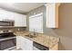 Well-lit kitchen with stainless steel appliances, granite countertops, and modern white cabinets at 285 Argus Nw Cir, Atlanta, GA 30331