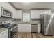 Bright kitchen featuring stainless steel appliances and sleek countertops at 3111 Flat Shoals Rd, Decatur, GA 30034