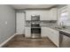 Updated kitchen featuring stainless steel appliances and granite countertops at 3111 Flat Shoals Rd, Decatur, GA 30034