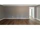 Open-concept living room with hardwood floors and neutral paint at 3111 Flat Shoals Rd, Decatur, GA 30034