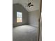 Neutral bedroom with a large window and plush carpeting at 4976 Notting Glen Ln, Snellville, GA 30039