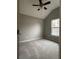 Neutral bedroom featuring vaulted ceilings, fan with lights, one window, and plush carpeting at 4976 Notting Glen Ln, Snellville, GA 30039
