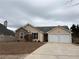 Charming single-Gathering home featuring stone accents and an attached two-car garage at 4976 Notting Glen Ln, Snellville, GA 30039