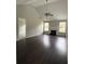 Spacious living room featuring a fireplace, hardwood floors, vaulted ceiling, and abundant natural light at 4976 Notting Glen Ln, Snellville, GA 30039