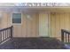 Back porch featuring wooden decking and a white entry door at 2958 Flat Shoals Rd, Decatur, GA 30034