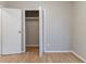 Bedroom with open closet and wood-look floors at 2958 Flat Shoals Rd, Decatur, GA 30034