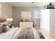 Bedroom features a large bed, neutral tones, bright window, and a dresser with stylish decor at 2958 Flat Shoals Rd, Decatur, GA 30034