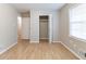 Bedroom features wood-look floors, closet, and a window at 2958 Flat Shoals Rd, Decatur, GA 30034
