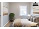 Bedroom with a bed, neutral-colored walls, bright window, and complementary decor create a serene and inviting atmosphere at 2958 Flat Shoals Rd, Decatur, GA 30034