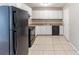 Kitchen featuring tile floors, white cabinets, essential appliances, and ample counter space for food preparation at 2958 Flat Shoals Rd, Decatur, GA 30034