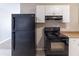 The kitchen features sleek, black appliances, durable countertops, and classic white cabinetry for a modern look at 2958 Flat Shoals Rd, Decatur, GA 30034