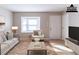 Cozy living room with a sofa, chair, rug, bay window and modern decor and hardwood floors at 2958 Flat Shoals Rd, Decatur, GA 30034