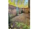 A small, secluded backyard has pea gravel, a weathered brick wall, and sparse plantings for easy maintenance at 3260 Henderson Mill Rd # A, Atlanta, GA 30341