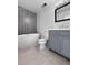 Bathroom featuring a tub, commode, and blue vanity with modern fixtures at 3260 Henderson Mill Rd # A, Atlanta, GA 30341