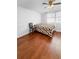 Bright bedroom with a fan, hardwood floors, white walls, and curtained windows at 3260 Henderson Mill Rd # A, Atlanta, GA 30341